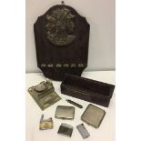 A small collection of smoking related items to include pipe rack and engine turned cigarette cases.