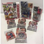 A collection of 8 Transformer toys as new in original packaging.
