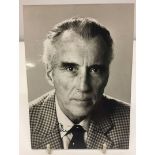 A signed black & white photograph of Christopher Lee (approx 12.5 x 18cm).