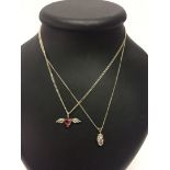 2 silver pendants on chains - 1. Oval crystal with silver crossing & 2. A pink shaped heart stone