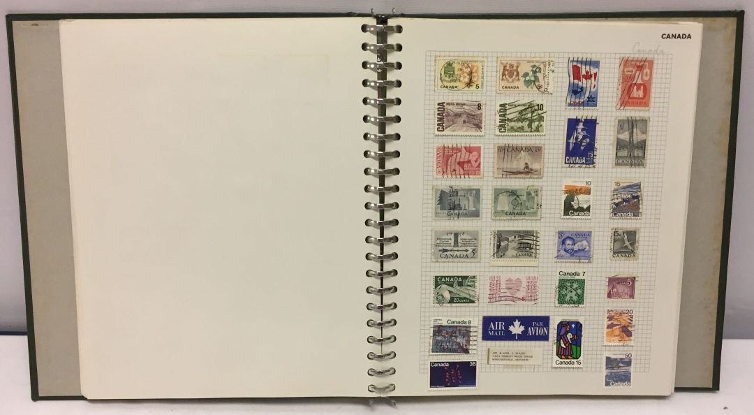 A green stamp album of stamps from around the world.