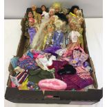 A box of 15 Barbies and 2 Ken dolls with a quantity fo clothes together with an Action Man.