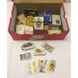 A box of playing cards and mixed teacards.