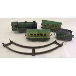 A small quantity of green tinplate toys. A train, 3 carriages and a small section of track.