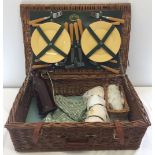 A vintage 'Optima' wicker picnic hamper with contents.