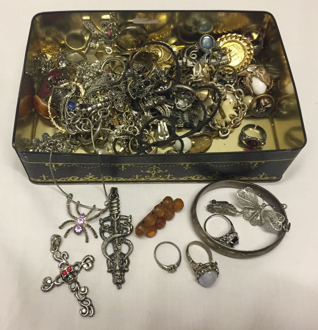 A tin containing a good quantity of costume jewellery.