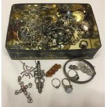 A tin containing a good quantity of costume jewellery.