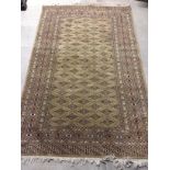 A wool rug in beige and brown colours. 197 x 27cm.