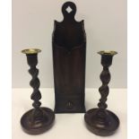 A pair of brass topped barley twist candlesticks together with a modern wooden candlebox.