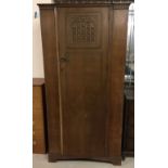 A vintage single wardrobe with portculis style decoration to door. Made by L. Marcus Ltd, London N1.