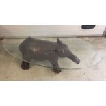 A modern glass topped coffee table with Elephant shaped base. Approx 122 x 42cm.