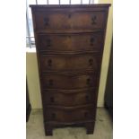 An early to mid 20th century serpentine fronted mahogany veneered 6 drawer chest of drawers with