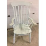 A farmhouse slatted seat armchair painted pale blue.