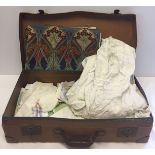 A vintage brown suitcase with contents to include material with Liberty 'Vat colours' pattern and