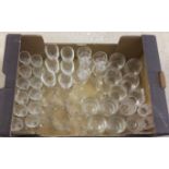 A box of sets of glasses to include champagne flutes and tumblers.