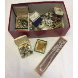 A box of costume jewellery to include a silver heart pendant and matching goldtone Movitex