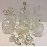 A quantity of glass decanters and stoppers.