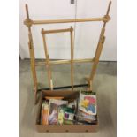 A box of vintage knitting patterns and sewing books together with a wooden embroidery work frame.