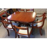 A maple extending dining room table with 4 chairs and 2 carvers all with cream upholstered seats.
