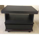 A modern TV stand on casters.