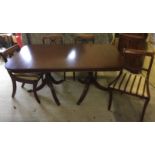 A modern extending dining table with pedestal legs, together with 4 matching dining chairs with