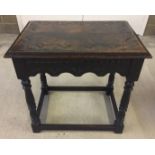 A vintage oak occasional table with carved detail to front and top.
