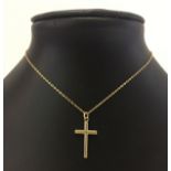 A 9ct gold cross shaped pendant on a small lightweight gold chain, total weight approx 1.9g.