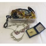 A small tub containing costume jewellery necklaces & beads to include diamante.