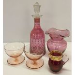 5 pieces of cranberry glass comprising: decanter, 2 sundae dishes, vase and a gilt collared jug.