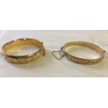 2 Nicely engraved 9ct rolled gold hinged bangles with safety chains, one by Gilerco.