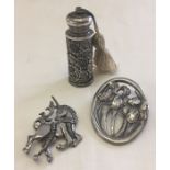 3 items of pewter comprising: a unicorn brooch by Albany Pewter, an oval brooch with Iris's by