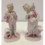 A pair of Plau-Im Havel porcelain boy and girl figures holding pets.