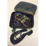 A blue & gold paper mache lidded box with contents to include bangles and necklaces.