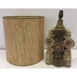 A single tier Bernard Rooke studio pottery lamp with original raffia drum lampshade. Brown & beige