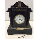 A Victorian French marble mantle clock. Movement marked AD Mougin. Black and brown marble with