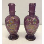 2 decorative handpainted amethyst coloured glass vases.