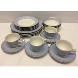 A Doulton 4 place setting in pale blue and white with gilt bands comprising 4 cups and saucers, 4