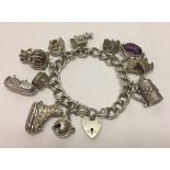 Large link silver charm bracelet with heart shaped 'padlock' fastening and safety chain. Has 10