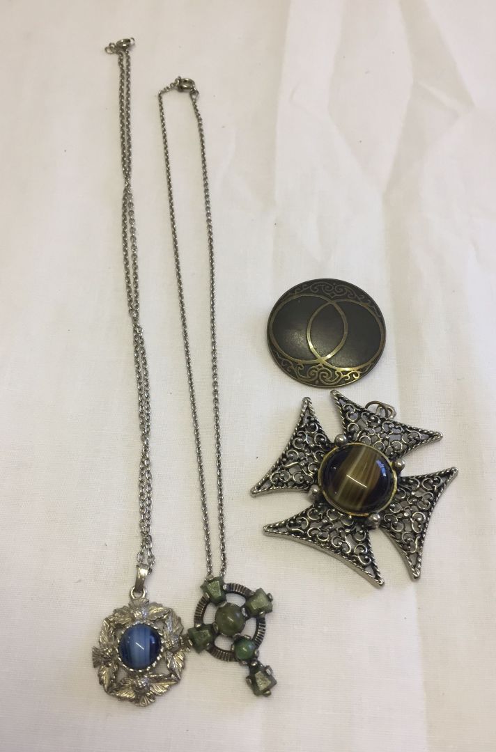 4 pieces of celtic style jewellery, 2 necklaces, 1 brooch and a large cross pendant.