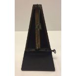 A wooden cased metronome made by J.T.L. Front to case missing.