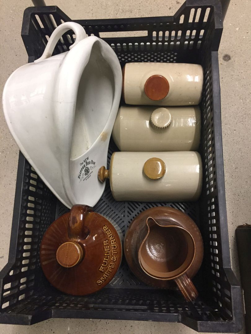 A crate of misc stoneware items comprising: 4 foot warmers, a large stoneware jug and a Fullers