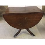 A dark wood drop leaf dining table with claw feet. 90cm wide x 75cm high.