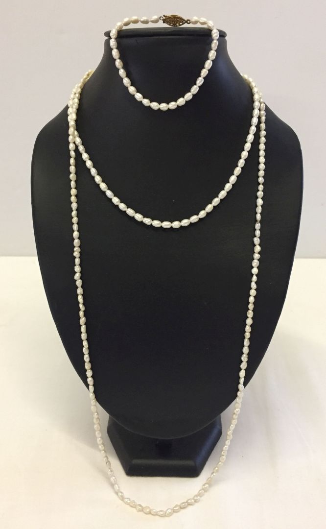 2 freshwater pearl necklaces, one approx 80cm long, the other approx 42cm long. Together with