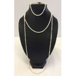 2 freshwater pearl necklaces, one approx 80cm long, the other approx 42cm long. Together with