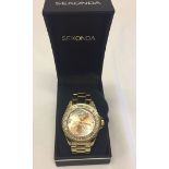 A ladies gold tone Seconda Seksy watch with flower detail to face.