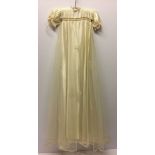 A c1940-50s ivory christening gown. Satin with net overlay.