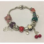 Truth silver snake charm bracelet with 14 charms of different designs.