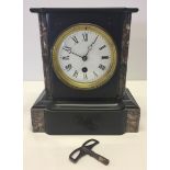 Victorian mantle clock. A black & brown mantle clock with enamelled dial. Has pendulum and key.