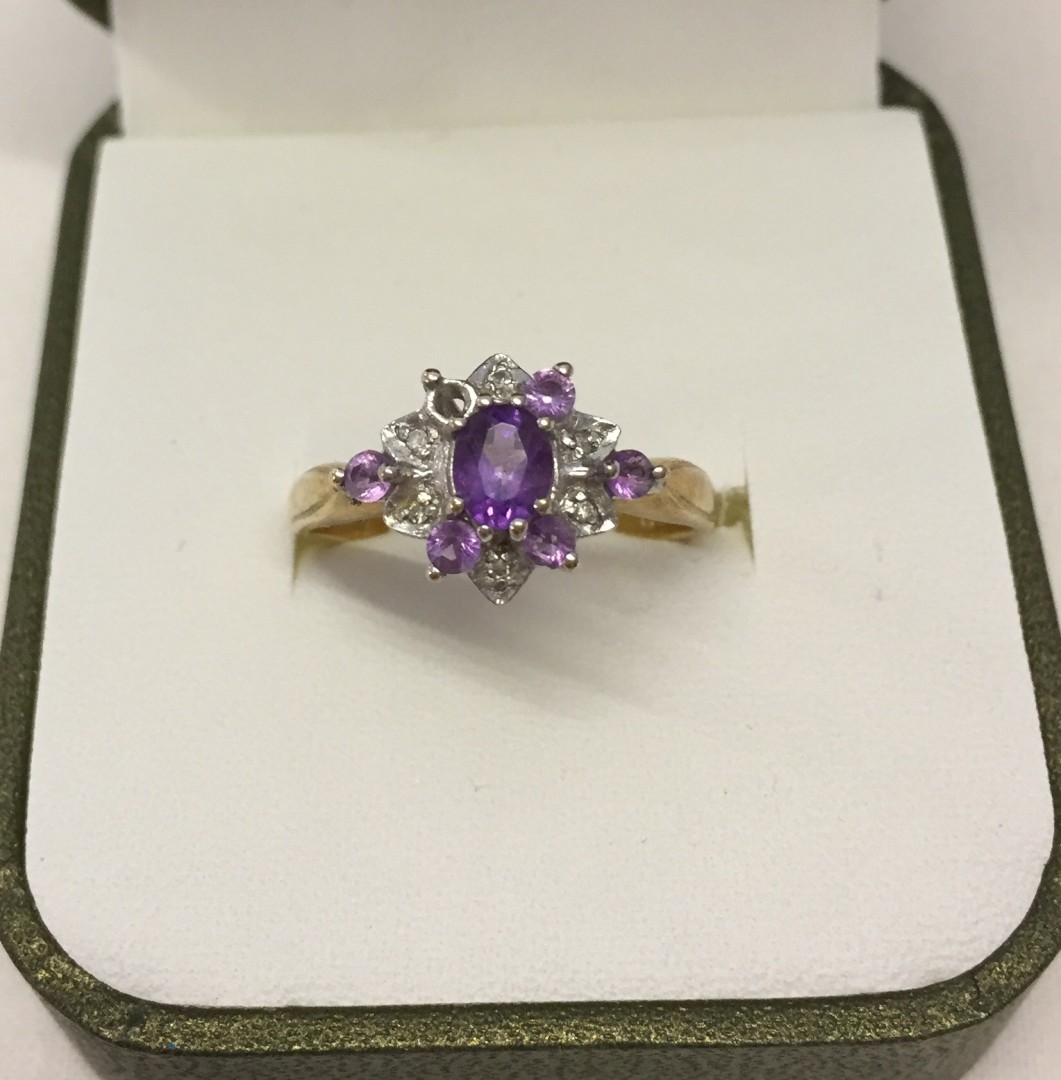 Pretty 9ct gold dress ring set with diamonds and amethyst, one small amethyst missing. Size P, total