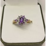 Pretty 9ct gold dress ring set with diamonds and amethyst, one small amethyst missing. Size P, total